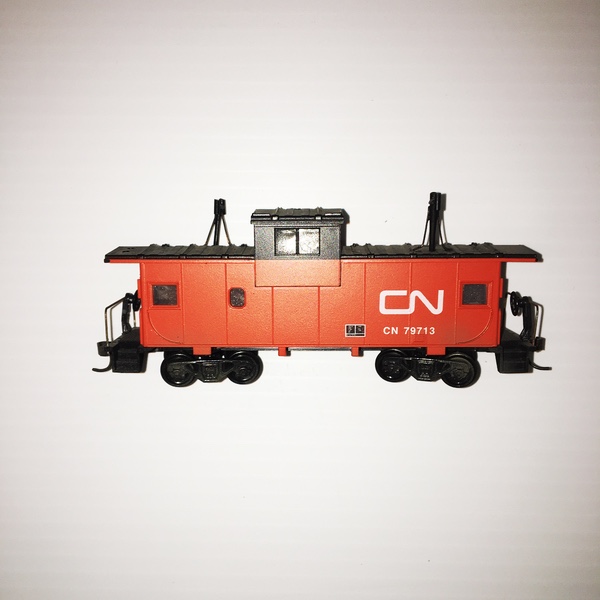 A red CN caboose, an HO-scale model