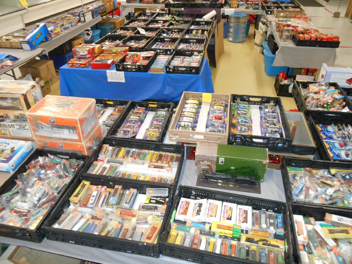 Vendor tables of boxed collectibles laid out at the market