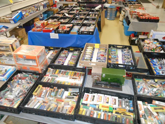 Vendor tables of boxed collectibles laid out at the market