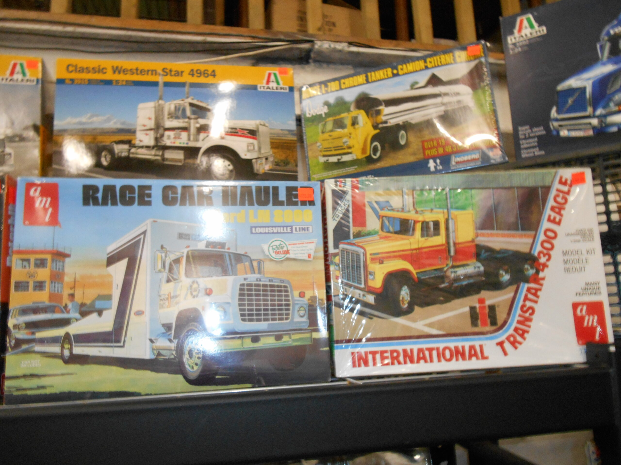 A shelf of boxed truck and transporter kits