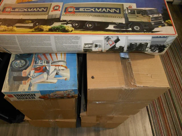 Boxed model kits stacked beside a display case