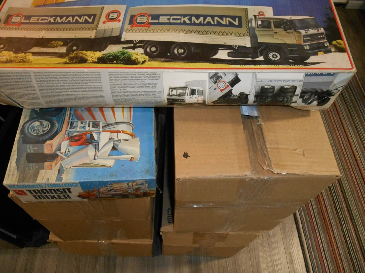 Boxed model kits stacked beside a display case