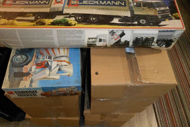 Boxed model kits stacked beside a display case