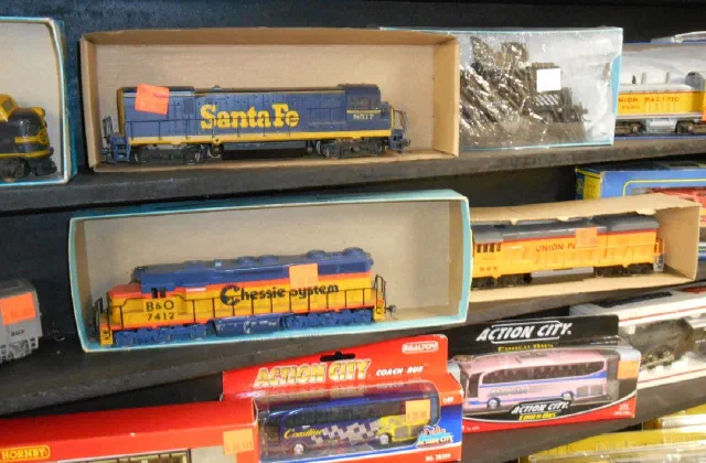 Boxed model locomotives and rolling stock on a shelf