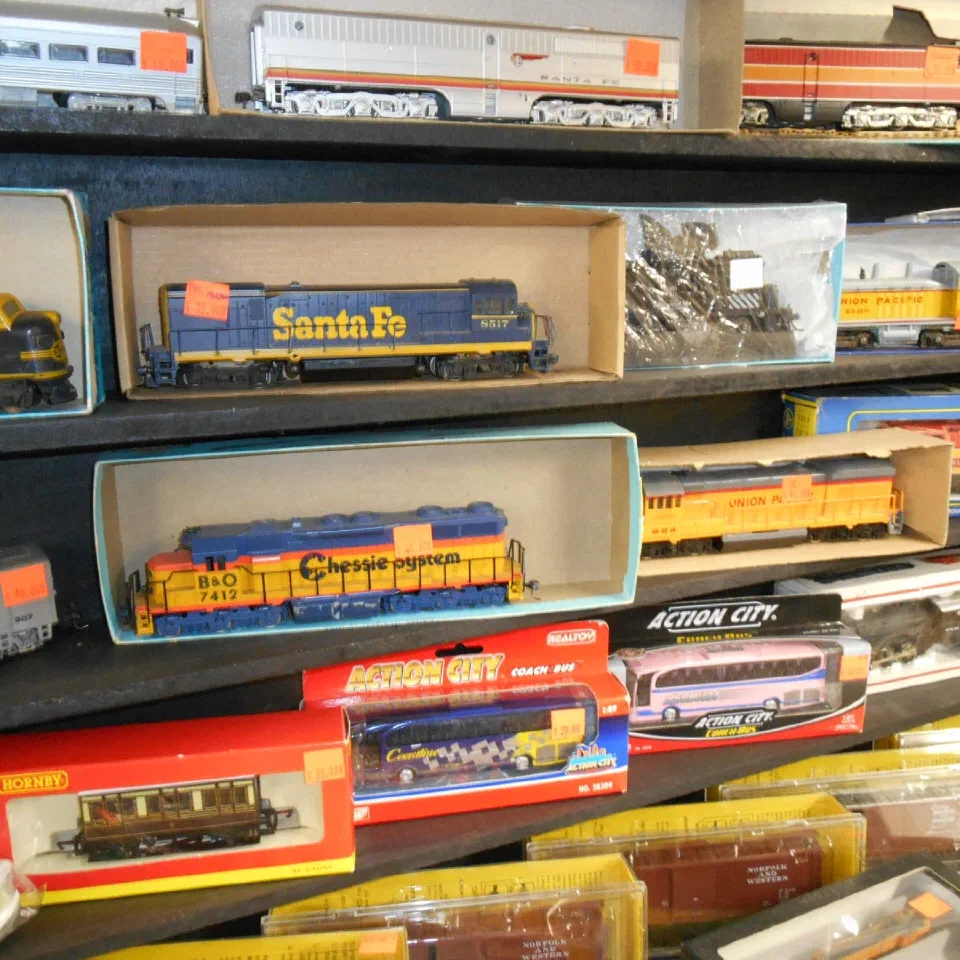 Boxed Santa Fe locomotives and rolling stock on a shelf